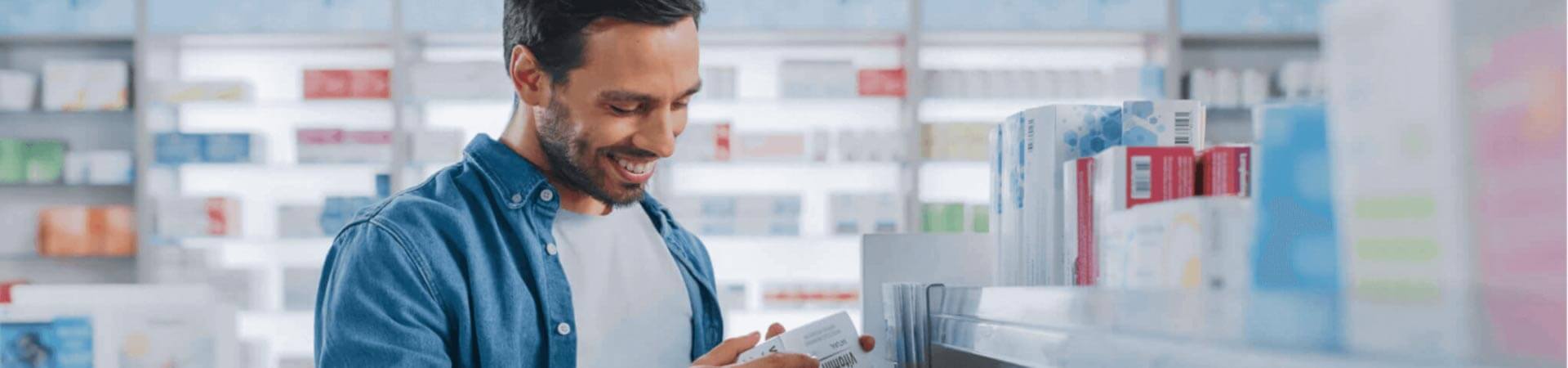 A Man holding medicine in his hand & smiling